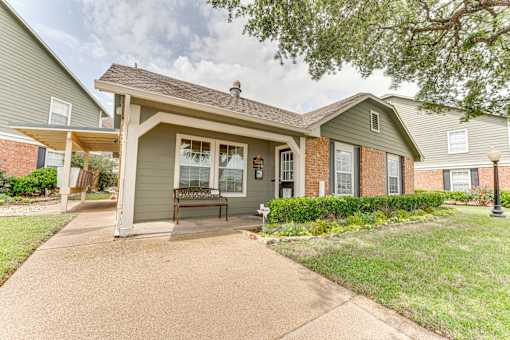 Single story home with front porch at Arbors Of Corsicana Apartments, Corsicana, TX