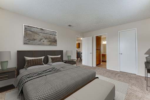 Master bedroom with ensuite bathroom and carpet flooring at Arbors Of Corsicana Apartments, Texas, 75110