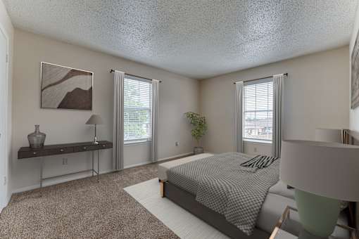 Spacious bedroom with dual windows and carpeting at Arbors Of Corsicana Apartments, Corsicana, TX 75110
