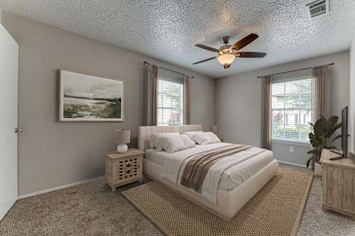 Bedroom with upholstered bed and ceiling fan at Arbors Of Corsicana Apartments, Texas, 75110