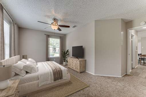 Bedroom with ceiling fan and wooden dresser at Arbors Of Corsicana Apartments, Corsicana, TX