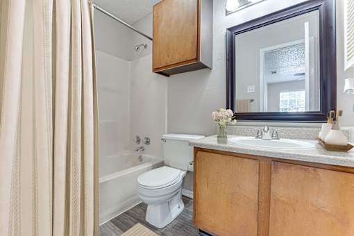 Full bathroom with vanity mirror and shower tub at Arbors Of Corsicana Apartments, Corsicana, 75110
