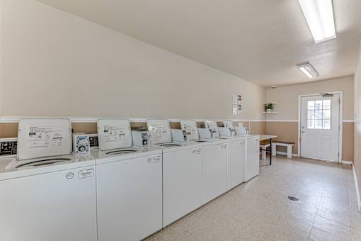 Shared laundry facility with multiple machines at Arbors Of Corsicana Apartments, Corsicana