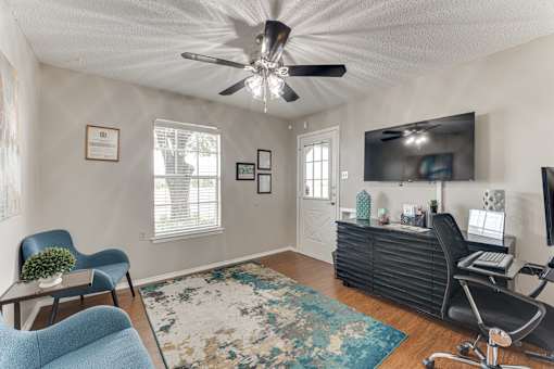 Office reception area with desk and seating at Arbors Of Corsicana Apartments, Texas