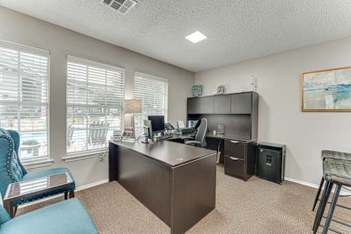 Home office with dark wood desk and storage at Arbors Of Corsicana Apartments, Corsicana, 75110