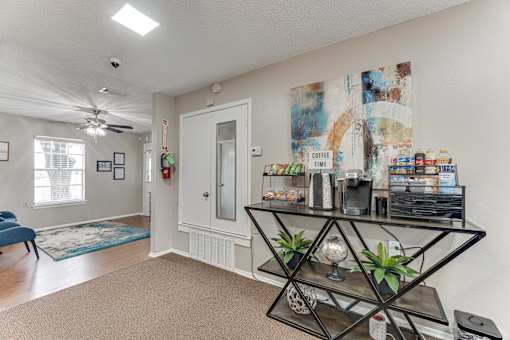 Coffee station and refreshment area with snacks at Arbors Of Corsicana Apartments, Corsicana, Texas