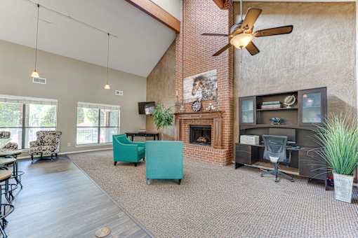A room with a fireplace and a ceiling fan.