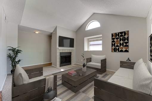 A living room with a fireplace and a television.