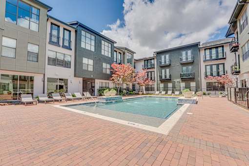 Courtyard pool with sundeck and lounge chairs at The Barton Apartments, Dallas, Texas