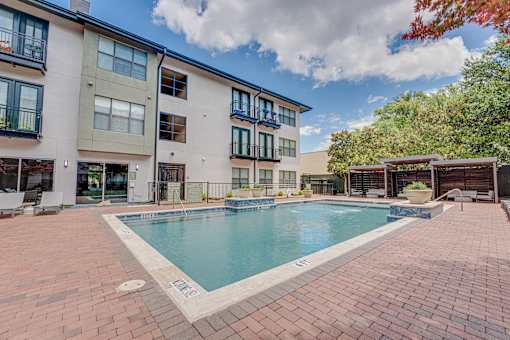 Outdoor pool area with spa and paver deck at The Barton Apartments, Texas, 75206