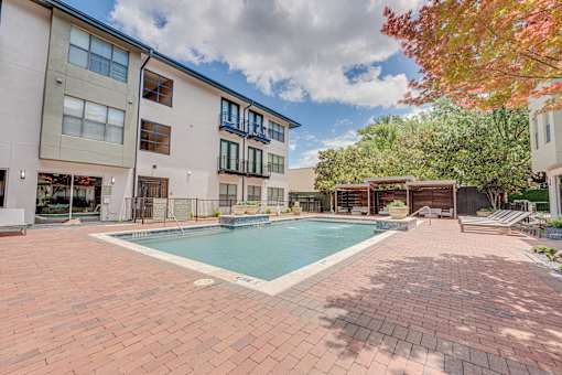 Swimming pool with cabanas and paver deck at The Barton Apartments, Dallas, TX 75206