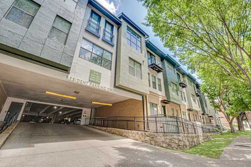 Resident parking garage entrance with street view at The Barton Apartments, Dallas, TX