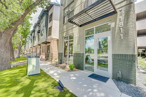 Leasing center entrance with glass doors at The Barton Apartments, Dallas, Texas