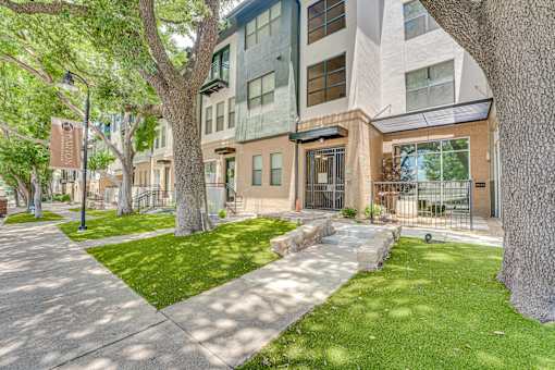 Modern townhome exterior with landscaped lawn at The Barton Apartments, Texas, 75206