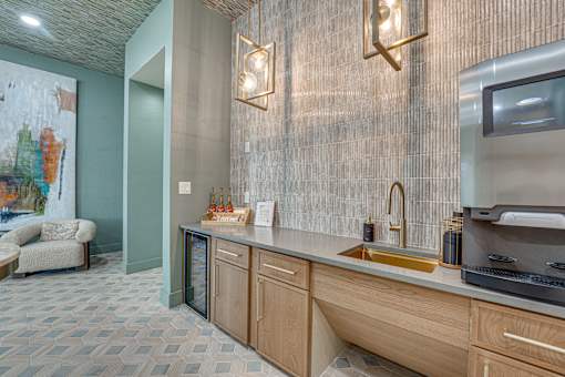 Wet bar area with gold sink and modern fixtures at The Barton Apartments, Texas