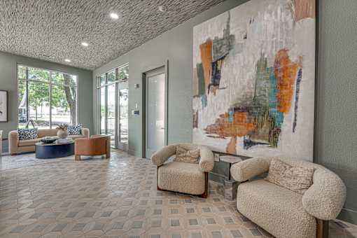 Lobby lounge with abstract artwork and seating at The Barton Apartments, Texas, 75206