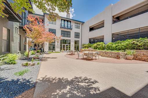 Courtyard patio with outdoor dining furniture at The Barton Apartments, Dallas, TX