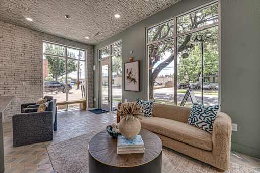 Lobby lounge with large windows and seating at The Barton Apartments, Dallas, 75206
