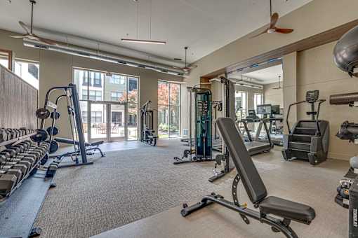Fitness center with cardio and strength equipment at The Barton Apartments, Texas