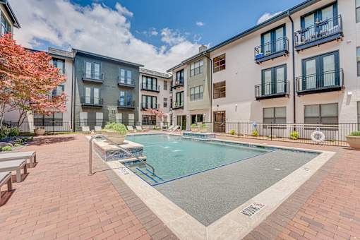 Swimming pool with hot tub and courtyard seating at The Barton Apartments, Dallas, TX 75206
