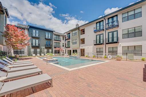 Courtyard pool with spa and lounge seating at The Barton Apartments, Dallas, TX