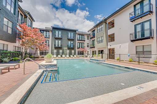 Pool courtyard with lounge seating and landscaping at The Barton Apartments, Dallas, 75206