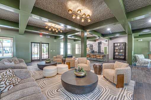 A living room with a large coffee table and a variety of seating options.