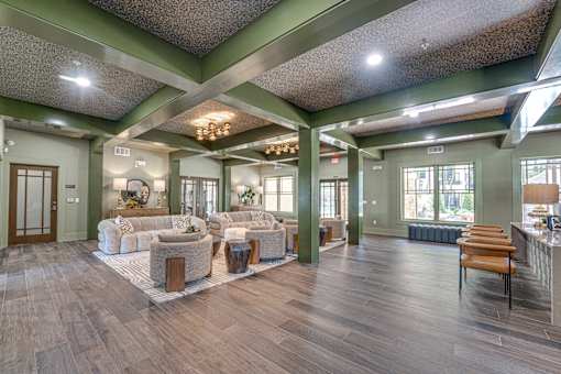 A spacious living room with a couch, chairs, and a coffee table.