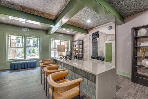 A row of bar stools are lined up in front of a counter.