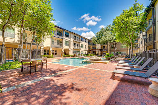 A sunny day at the poolside of a residential building.
