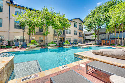 A pool with a "No Diving" sign in the foreground.