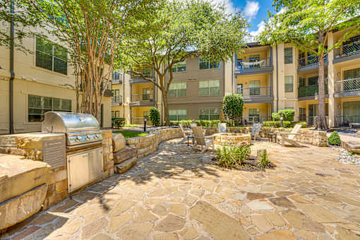 A courtyard with a stone floor and a wall with a mailbox on it.