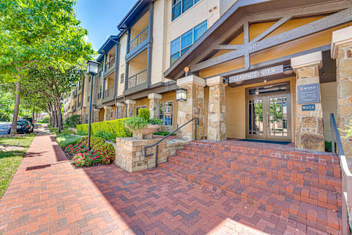 A brick pathway leads to a building entrance.