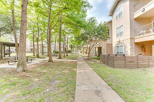 sidewalk in front of apartment buildings. at The Brazos, Dallas, Texas