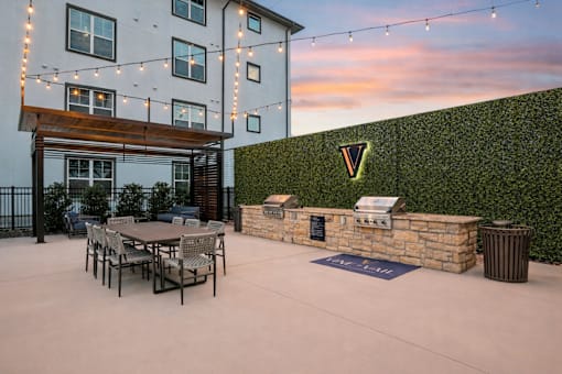 patio area with a table and chairs at Vine + Vail Townhomes and Apartments, Texas
