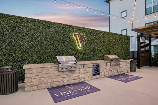 wall of greenery with a Vineyard sign at Vine + Vail Townhomes and Apartments, Grapevine