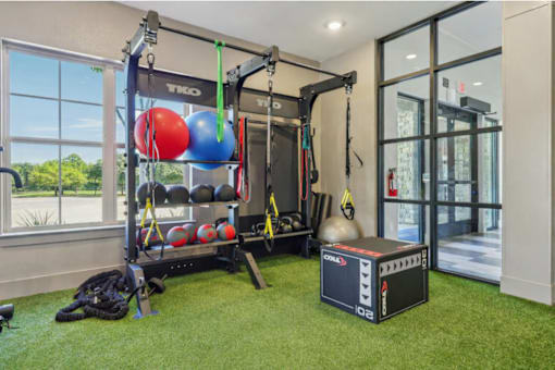 home gym with a squat rack at Vine + Vail Townhomes and Apartments, Texas, 76051