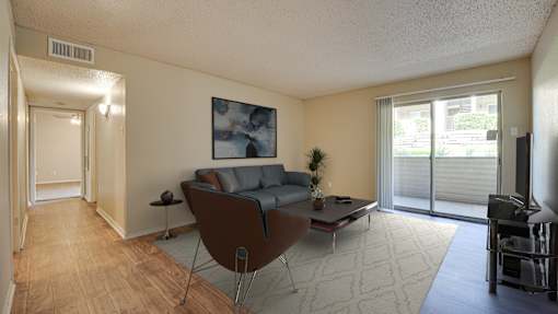 A living room with a brown chair and a grey couch at Copper Hill Apartments, Texas, 76021