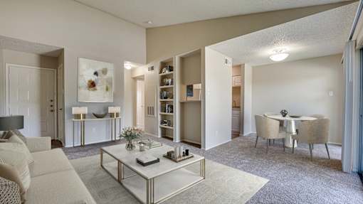 A living room with a white sofa, a coffee table, and a dining table with chairs at Copper Hill Apartments, Texas, 76021