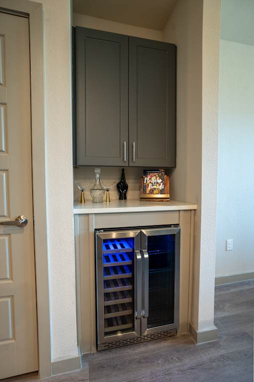 A wine cooler is built into a kitchen island.