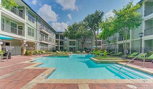 A swimming pool surrounded by apartment buildings.