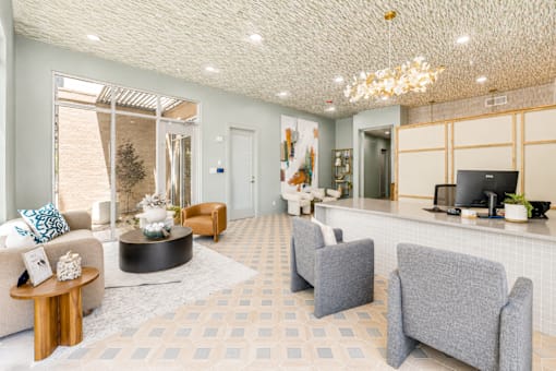 Leasing office lobby with reception desk and chandelier at The Barton Apartments, Dallas, TX 75206