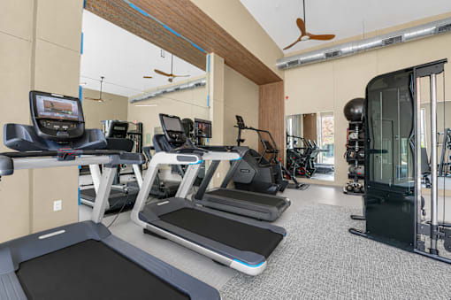 Fitness center with treadmills and weight machines at The Barton Apartments, Dallas
