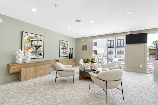 Community lounge with natural wood credenza and seating at The Barton Apartments, Texas, 75206