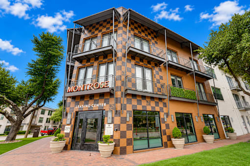 Leasing center entrance with checkered facade at The Montrose Apartments, Dallas, TX