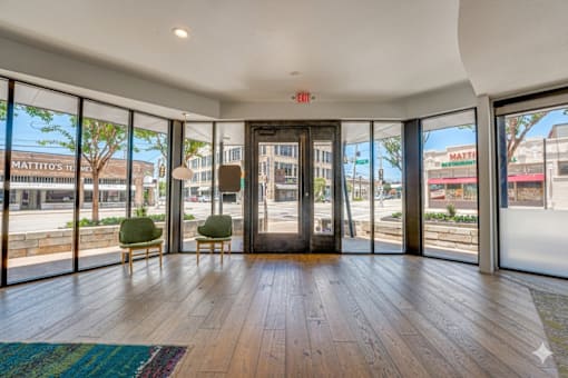 Modern lobby entrance with floor to ceiling windows at Vue Live Oak Apartments, Dallas, Texas