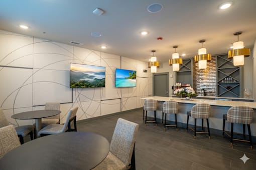 A modern dining area with a bar and chairs.