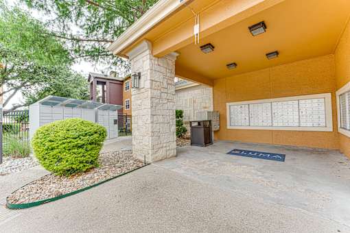 A yellow building with a parking sign in front at Limestone Ranch Apartments, Lewisville