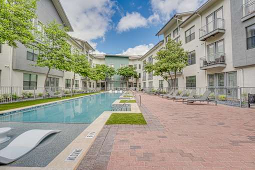 Courtyard pool area with paver deck at The Montrose Apartments, Dallas