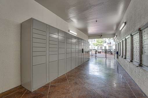Package locker room with parcel lockers and mailboxes at The Montrose Apartments, Dallas, TX 75204